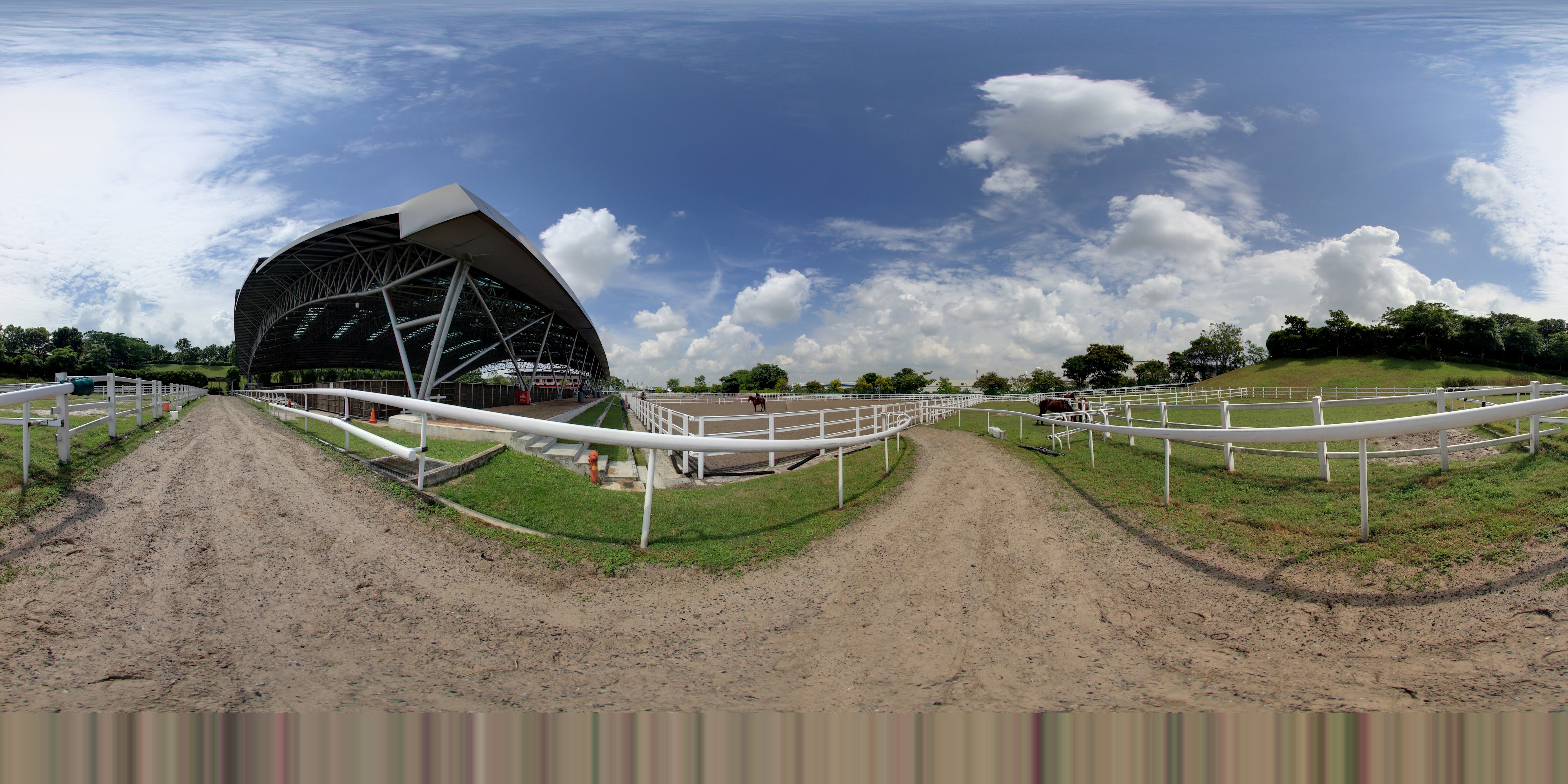Horses, Track, and Sky Covered Grandstand